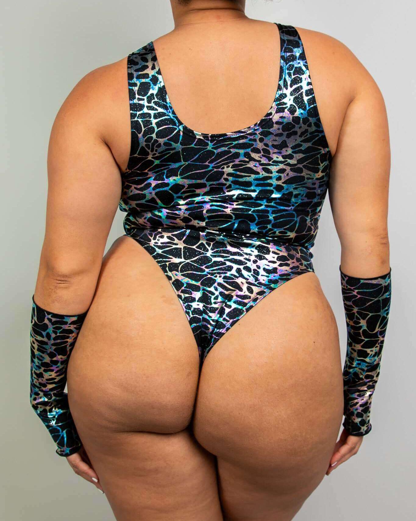 Back view of a model wearing the Galactica Keyhole Bodysuit, showcasing the high hip and thong design perfect for rave outfits.