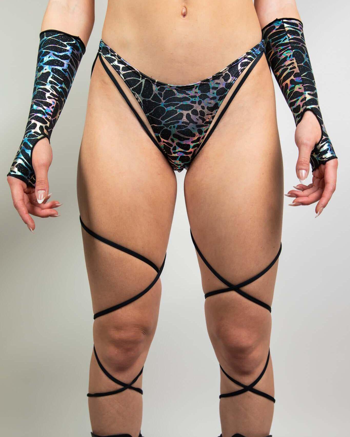 Galactica High Hip Strappy Bottoms with unique black and oil slick design, perfect for rave outfits.