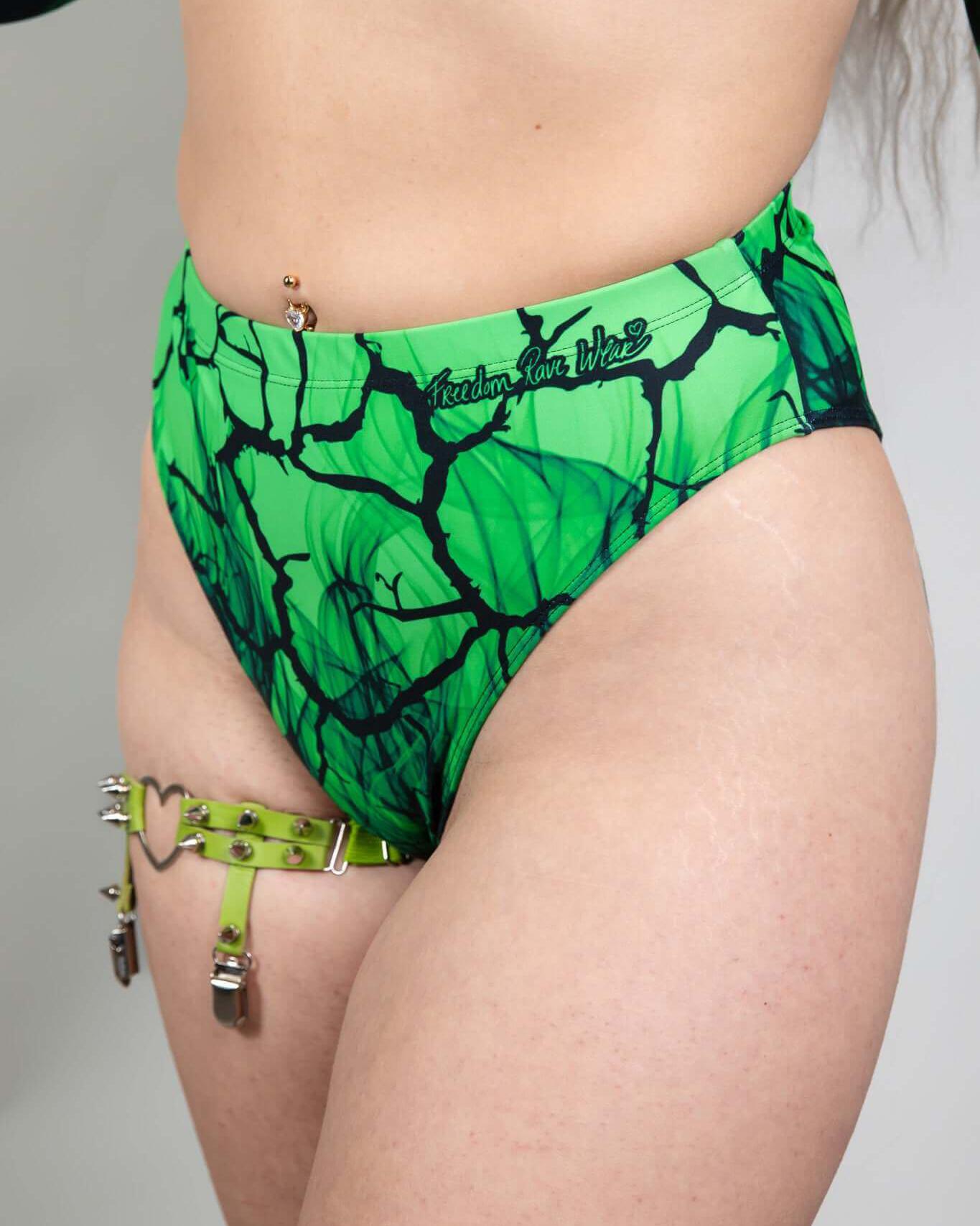 High-waisted Brazilian bottoms in green toxic design, perfect for rave outfits, featuring a sustainable fabric blend.