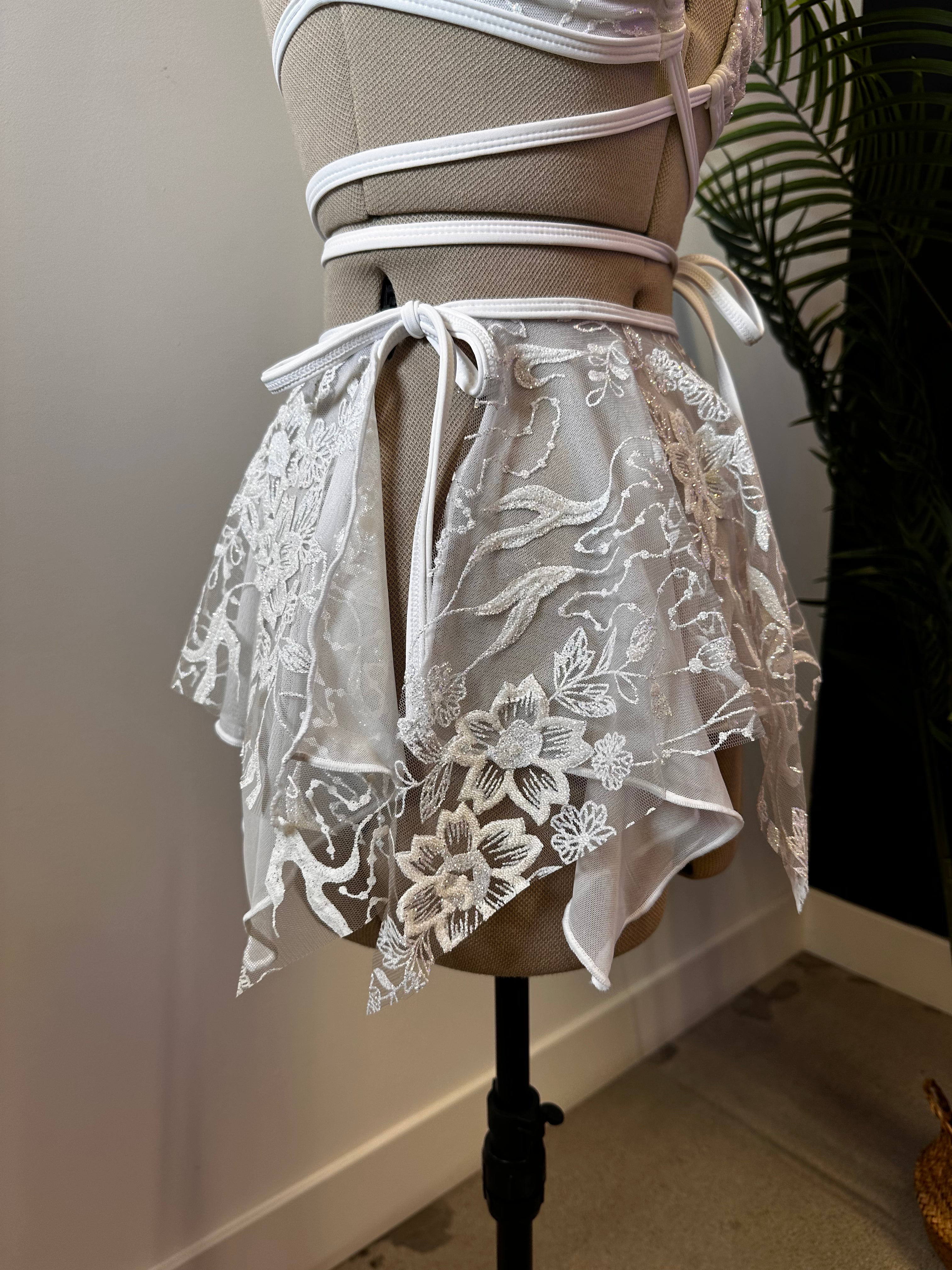 Seraphina Fairy Skirt in white, side view, showcasing layered lace design with asymmetrical hem and tie waist, perfect for enchanting style.