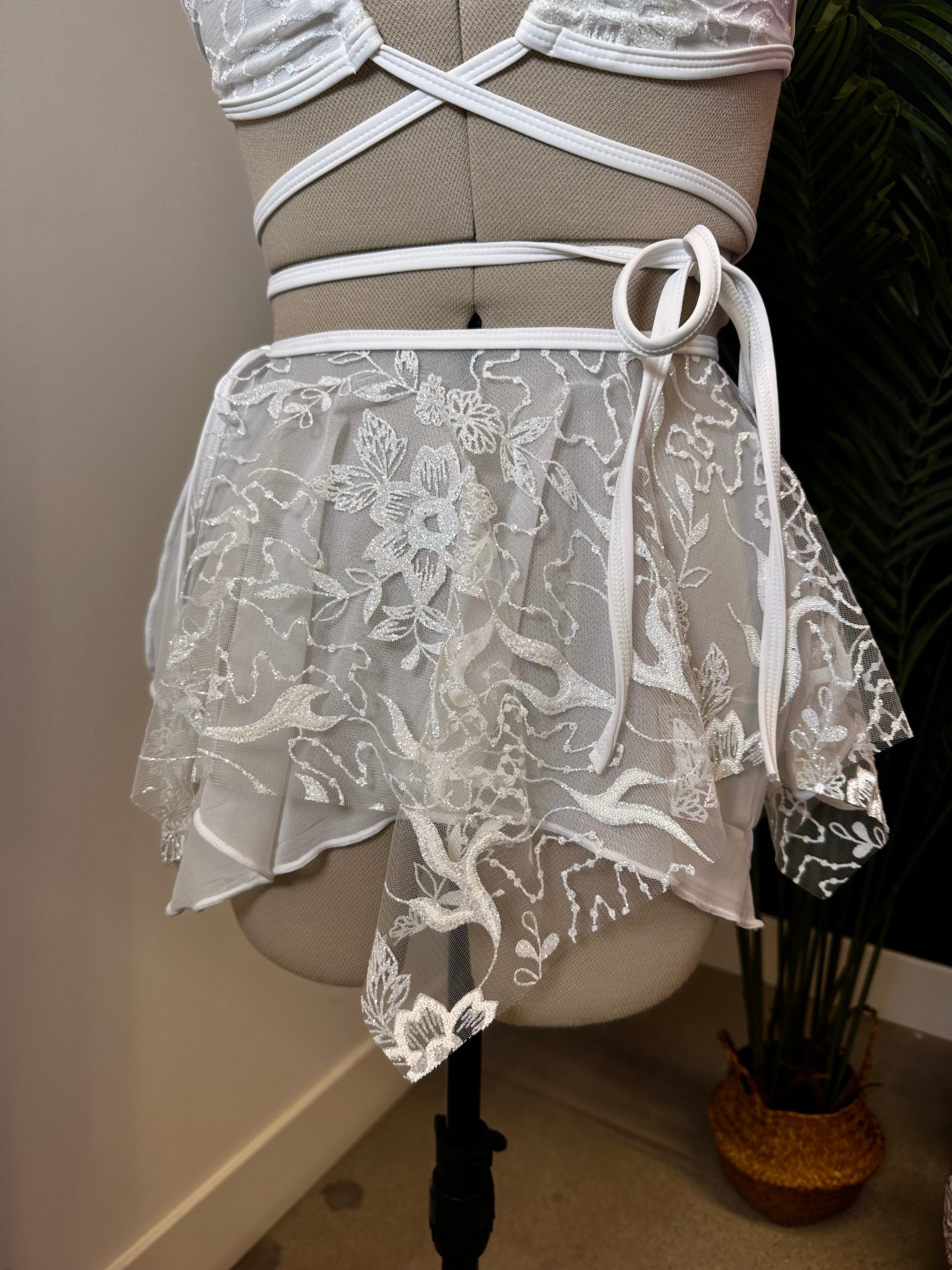 Seraphina Fairy Skirt in white, front view, lace layers with asymmetrical hem and tie waist, perfect for rave fashion and festival wear.