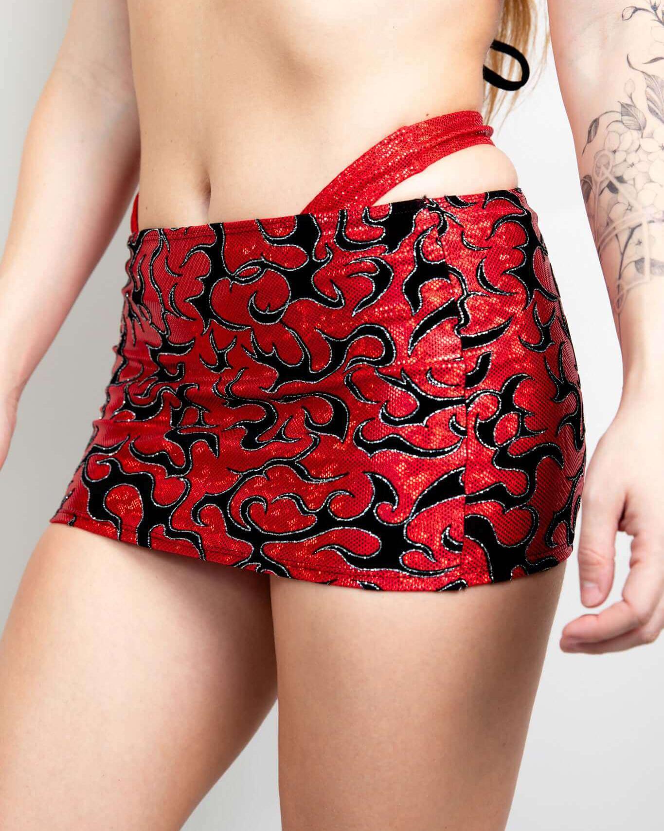 Red and black patterned Inferno Cinch Skirt styled for a rave outfit, showcasing adjustable length and ruched design.