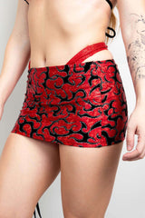 Red and black patterned Inferno Cinch Skirt styled for a rave outfit, showcasing adjustable length and ruched design.