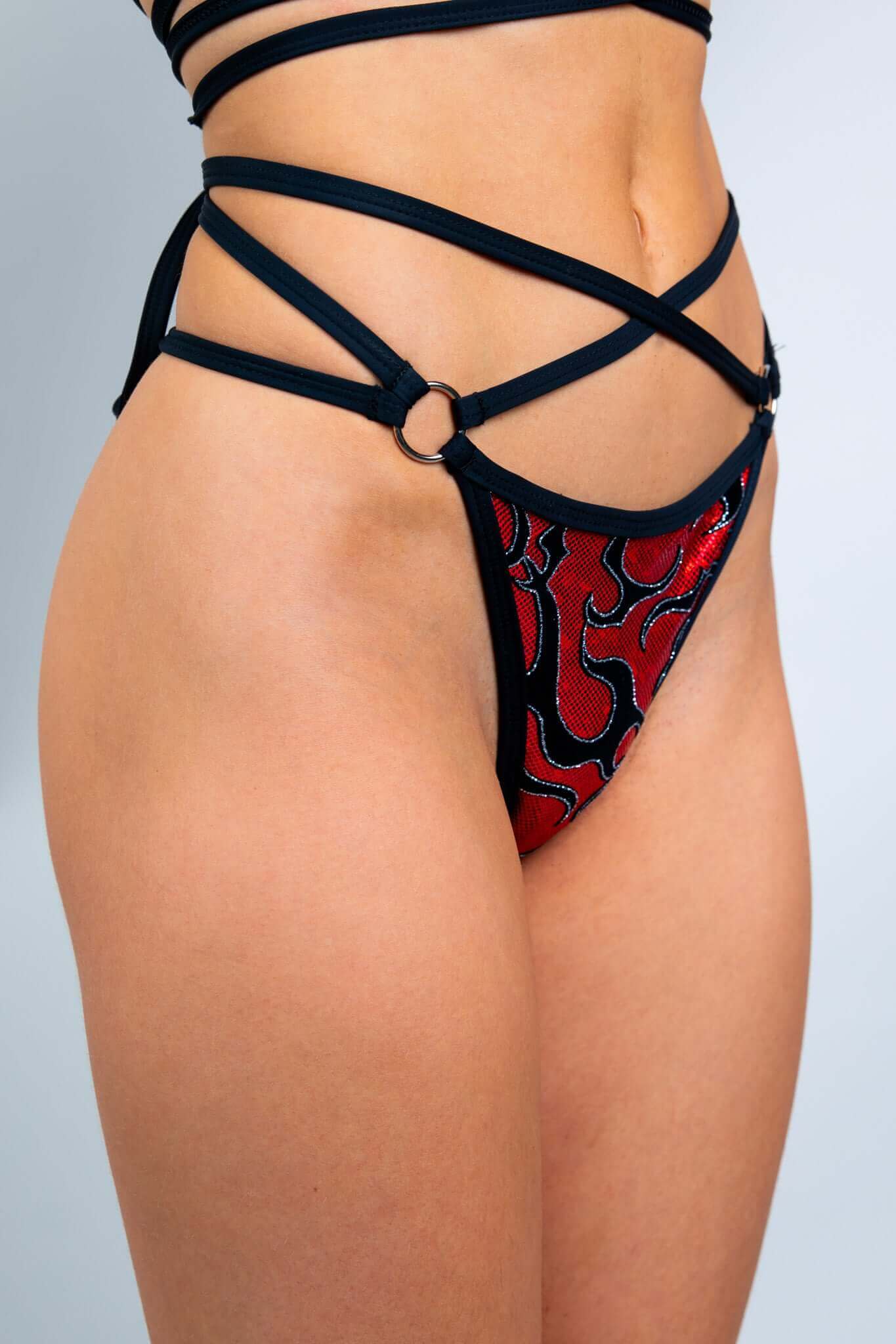 Freedom Rave Wear red and black thong bikini bottoms feature bold patterns, adding vibrant style to rave outfits. Perfect for standing out.