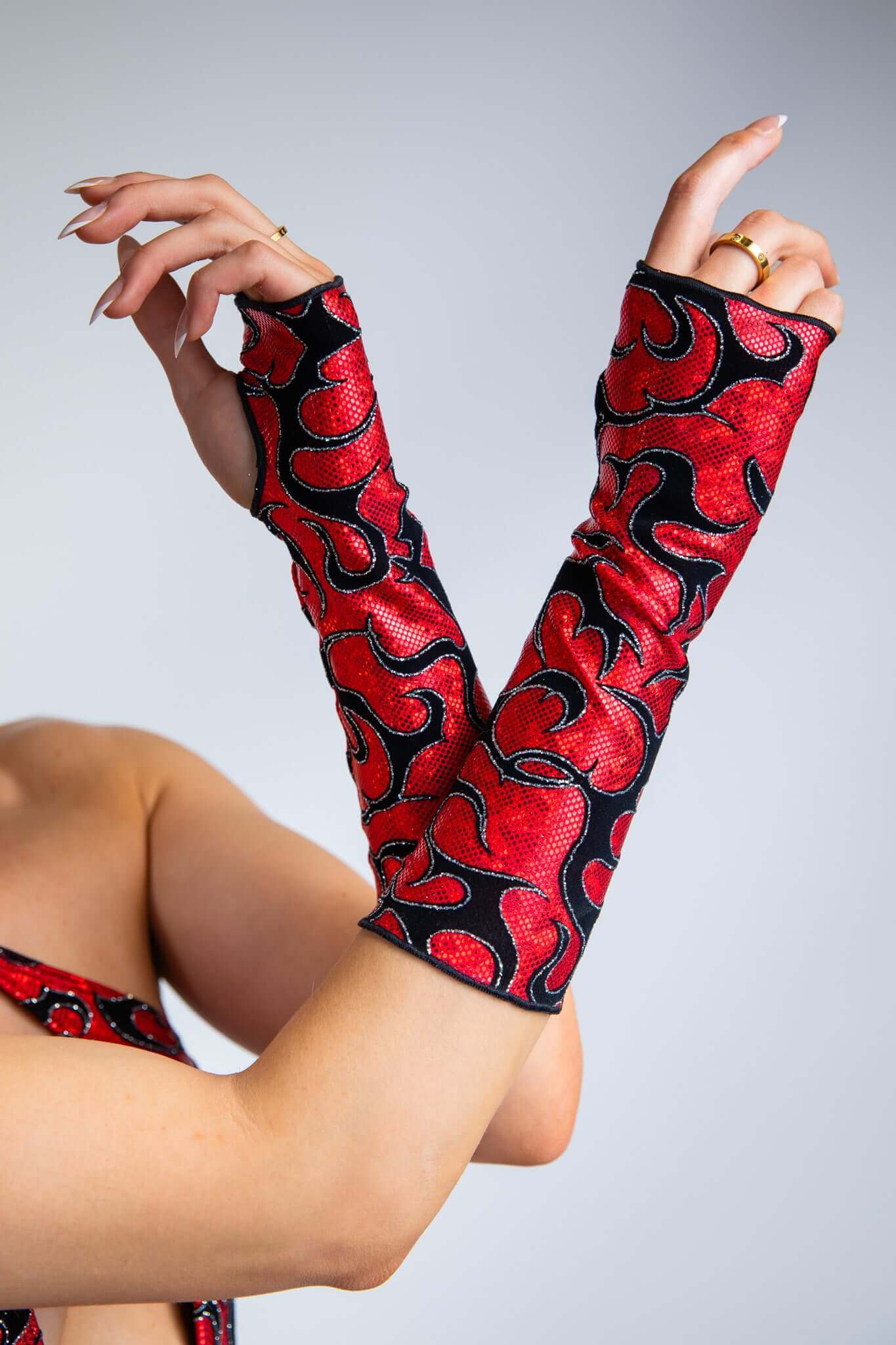 Freedom Rave Wear Inferno gloves in red with bold black patterns add vibrant style to rave outfits. Perfect for making a unique statement.