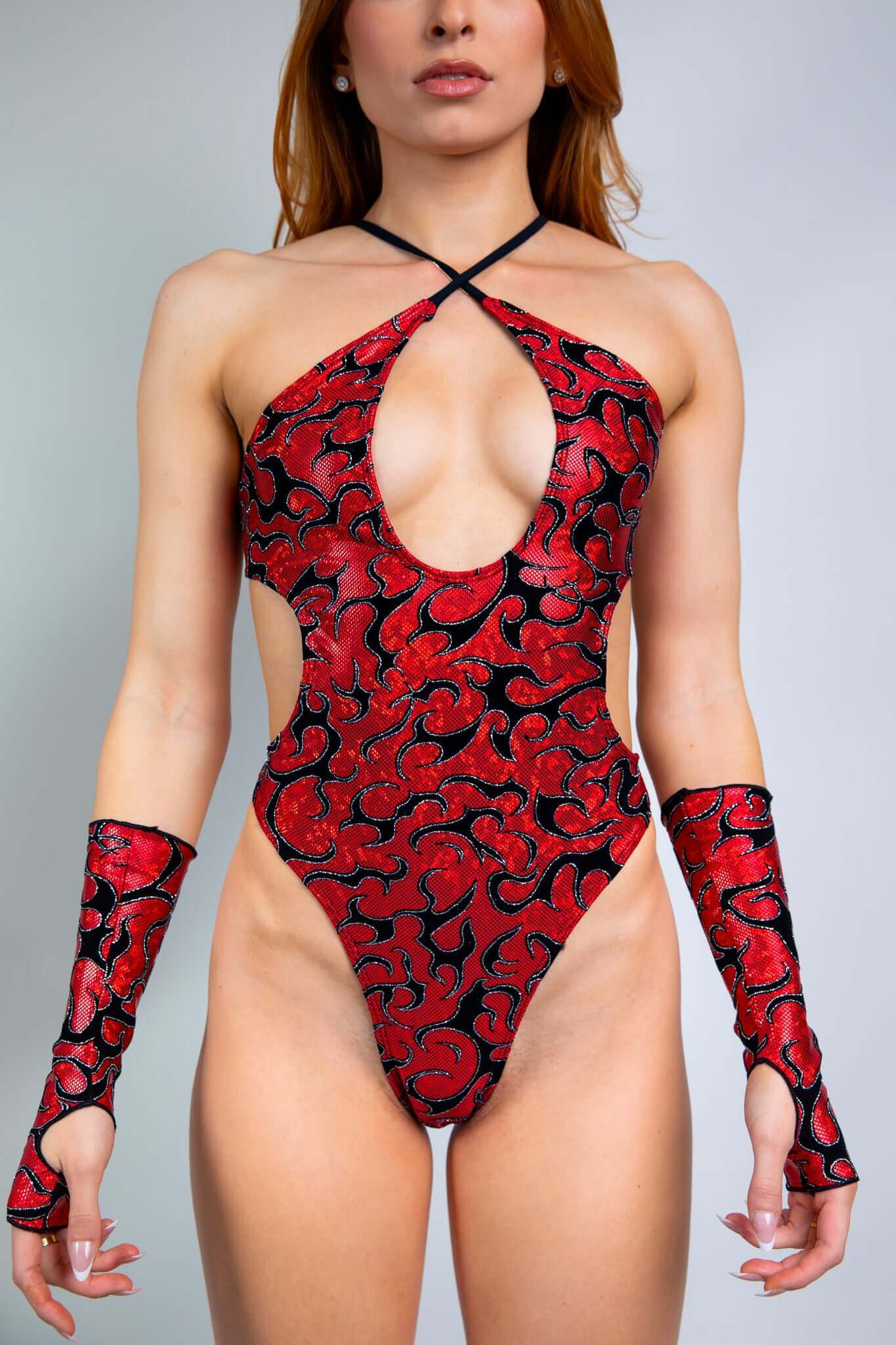 Freedom Rave Wear Inferno gloves and bodysuit in red with bold black patterns add vibrant style to rave outfits. Perfect for standing out.