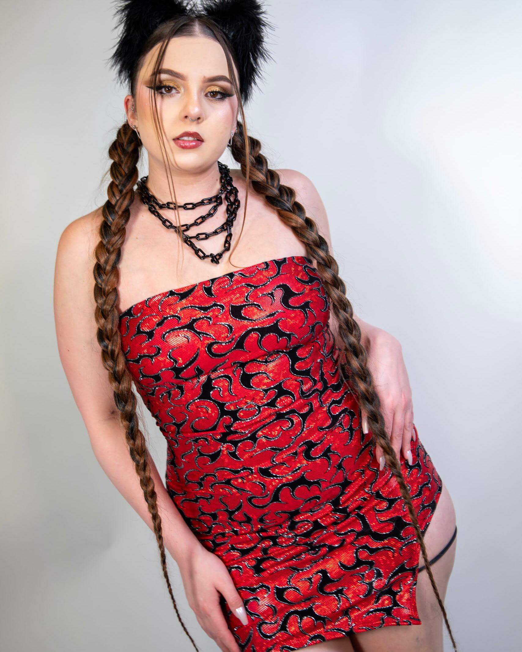 Front view of the Inferno Christina Dress featuring red holographic fabric with velvet flame details for a bold, fiery look.