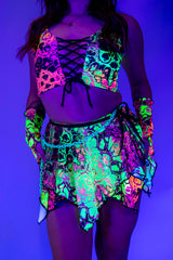 Model wearing a vibrant neon Intensity Fairy Skirt and matching top, perfect for rave outfits in blacklight.