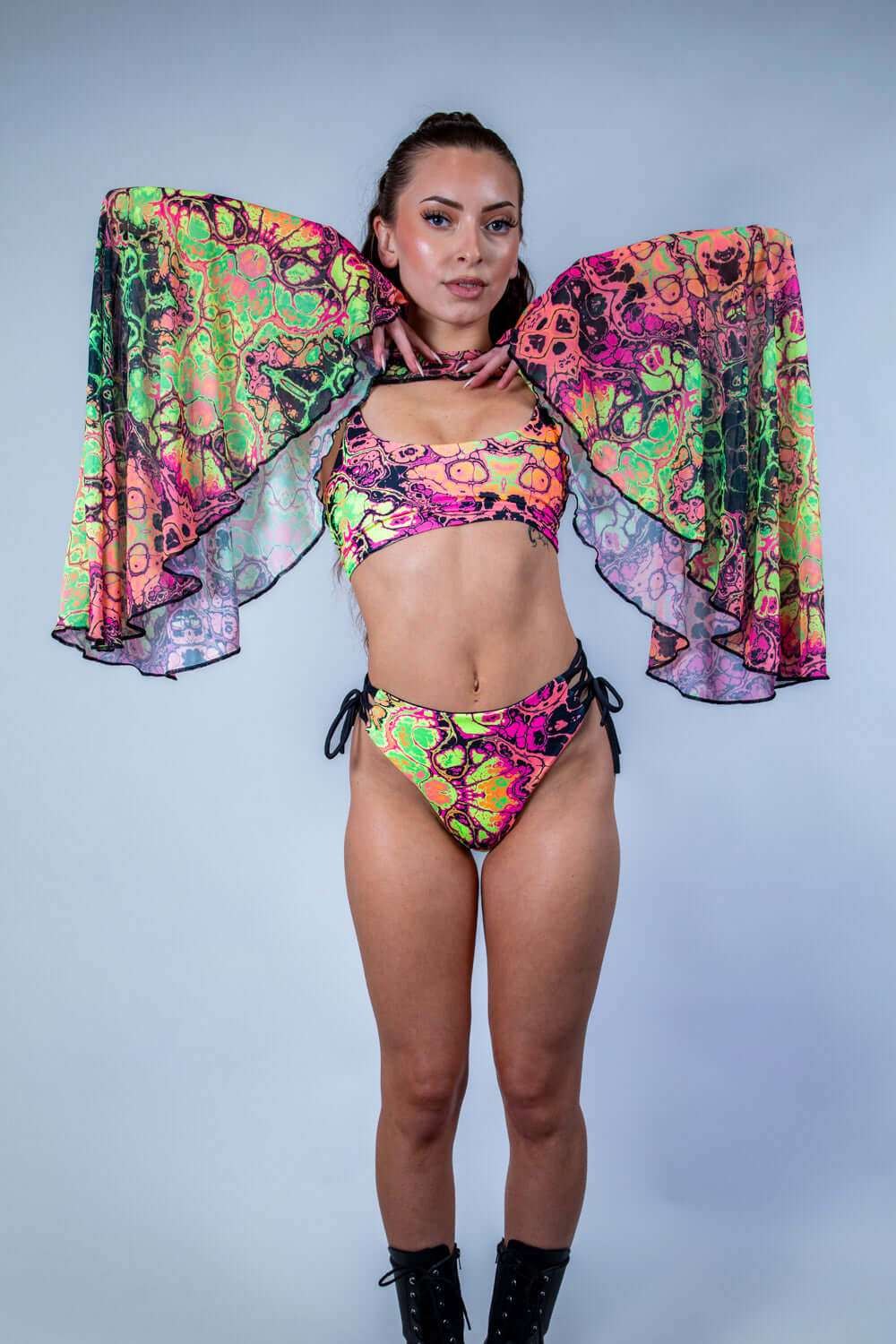 Model wearing colorful Intensity Mesh Bell Sleeves with matching rave outfit, perfect for festivals and parties.