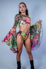 Model showcasing Intensity Mesh Bell Sleeves with matching rave outfit in vibrant UV reactive colors.