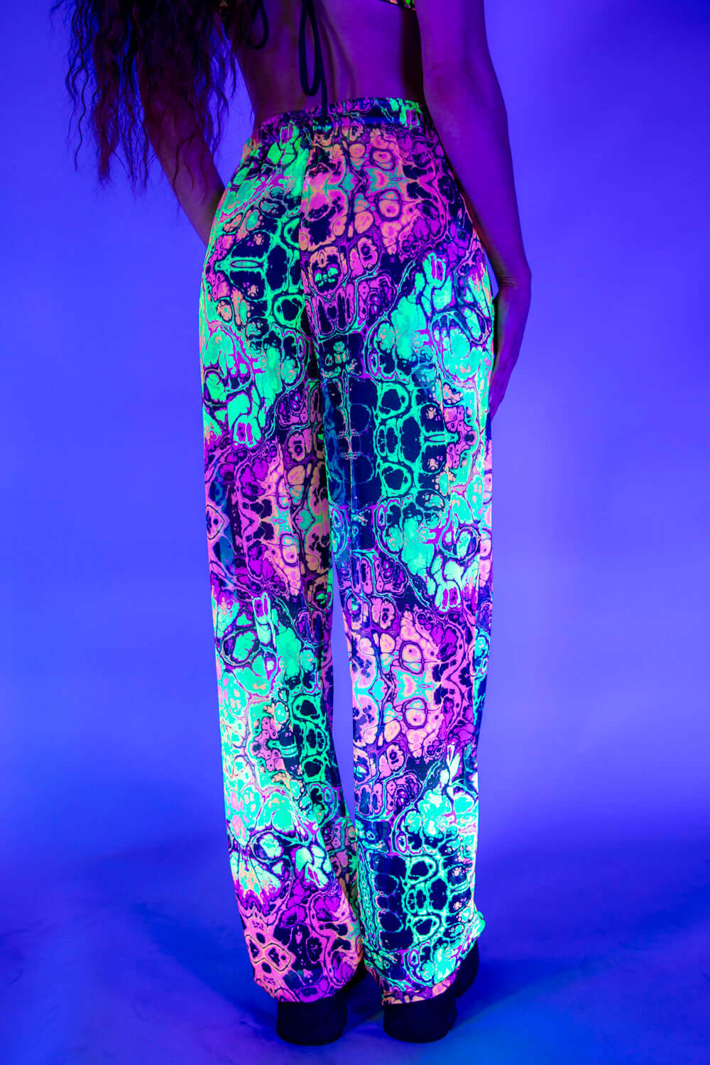 Colorful rave pants with neon skull print, perfect for festivals and comfortable loose fit.