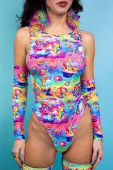 A woman wearing a rainbow bodysuit with whimsical characters on it.