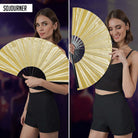 Festival Fans in vibrant gold color held by a woman showcasing a stylish look for rave outfits.