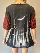 Model wearing a Labyrinth Oversized Softee, back view showing black and red graphic print with short sleeves and distressed details.