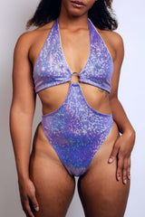 Front profile of a model wearing a shimmering lavender ring bodysuit from Freedom Rave Wear, styled for a dynamic look