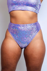 Rear view of a model in a shimmering lavender high-waist bottom from Freedom Rave Wear.