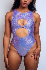 Striking lavender glitter bodysuit featuring dual keyhole cuts and a metallic finish, from Freedom Rave Wear