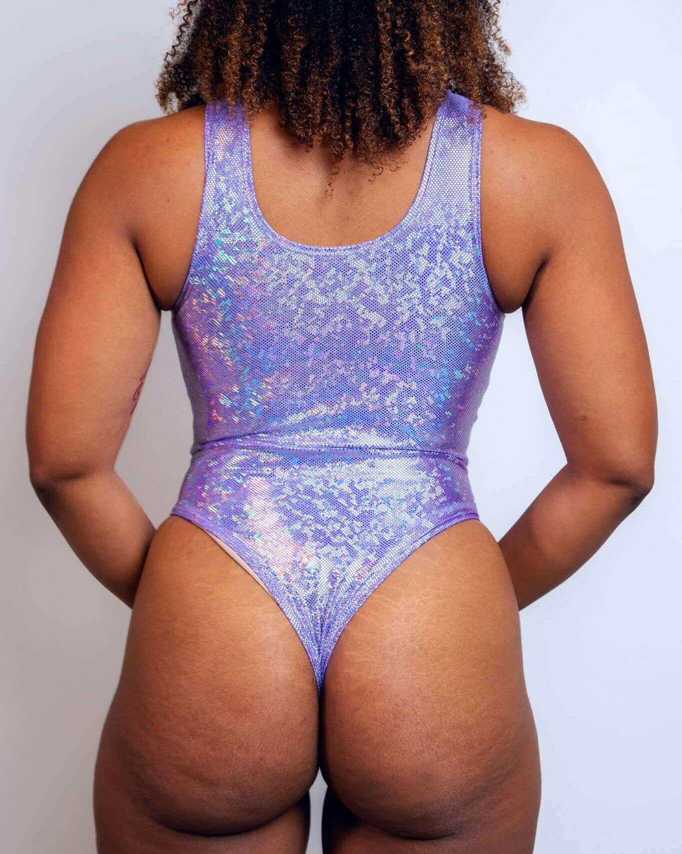 Back view of a sparkly lavender holo keyhole bodysuit, perfect for rave outfits and summer festivals.