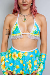 Model wearing Lemon Drop Bikini Top with Ruffles, featuring lemon prints and coquette ruffles, perfect for rave outfits.