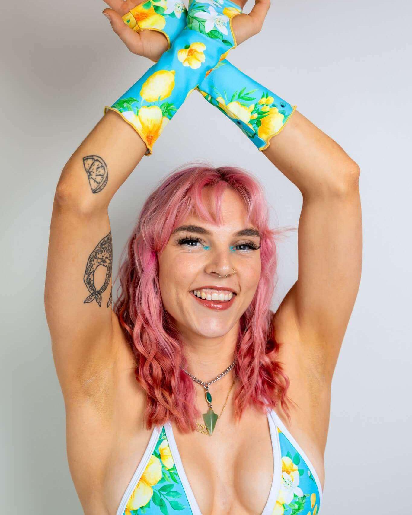 Lemon Drop Gloves showcased by a smiling model, perfect for rave outfits with a colorful floral design.