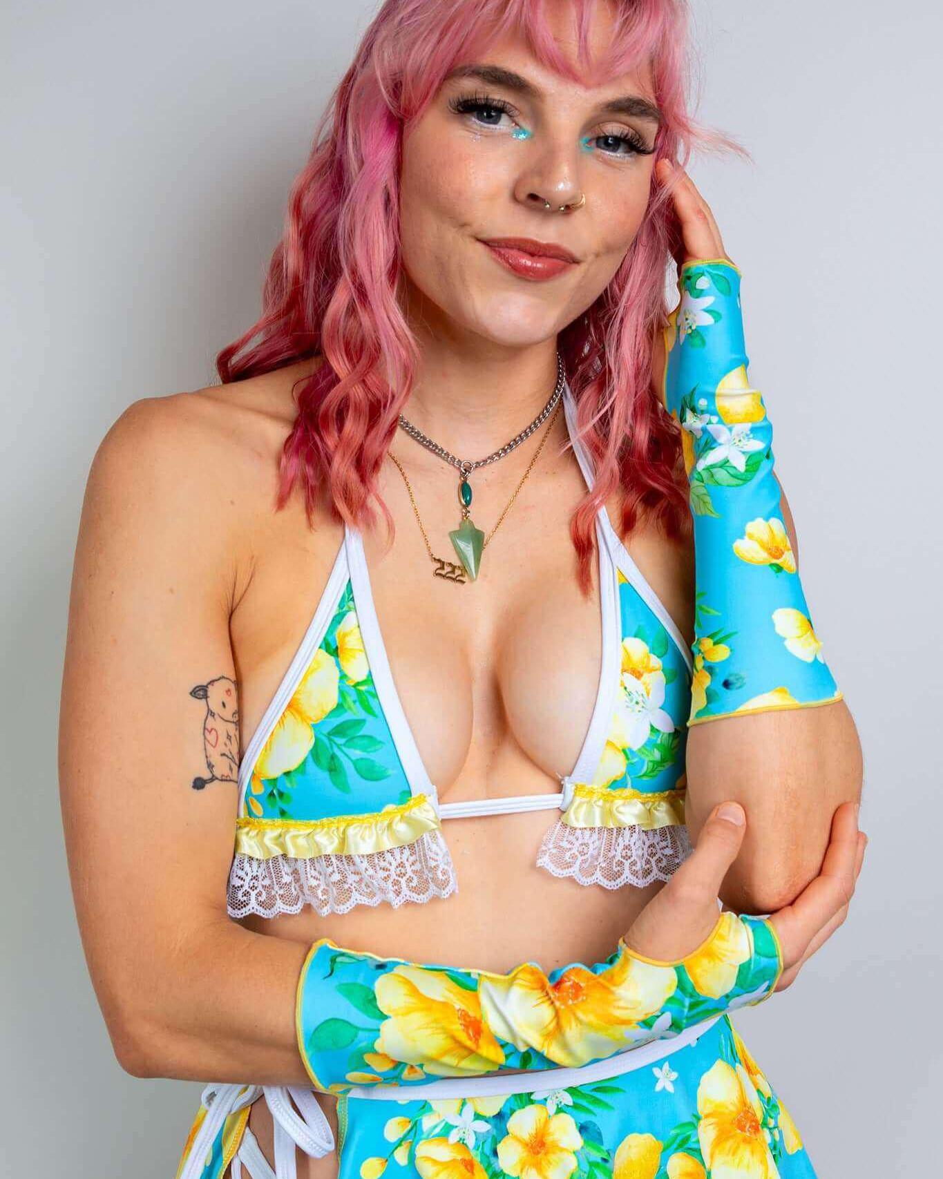 Model wearing Lemon Drop Gloves with a floral outfit, perfect for rave outfits and summer festivals.