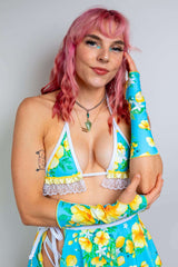 Model wearing Lemon Drop Gloves with a floral outfit, perfect for rave outfits and summer festivals.