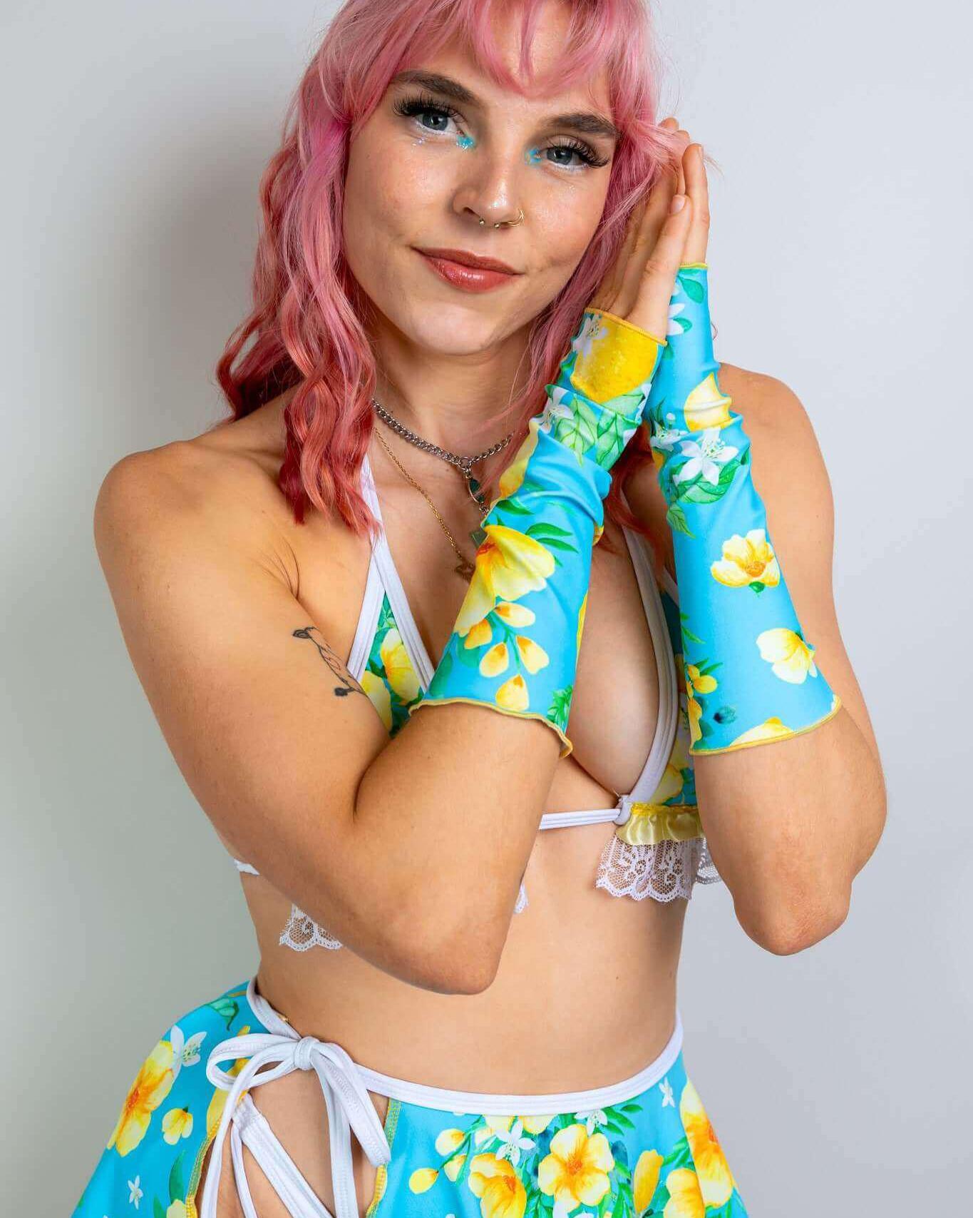 Model showcasing Lemon Drop Gloves in colorful lemon print, perfect for rave outfits and summer festivals.