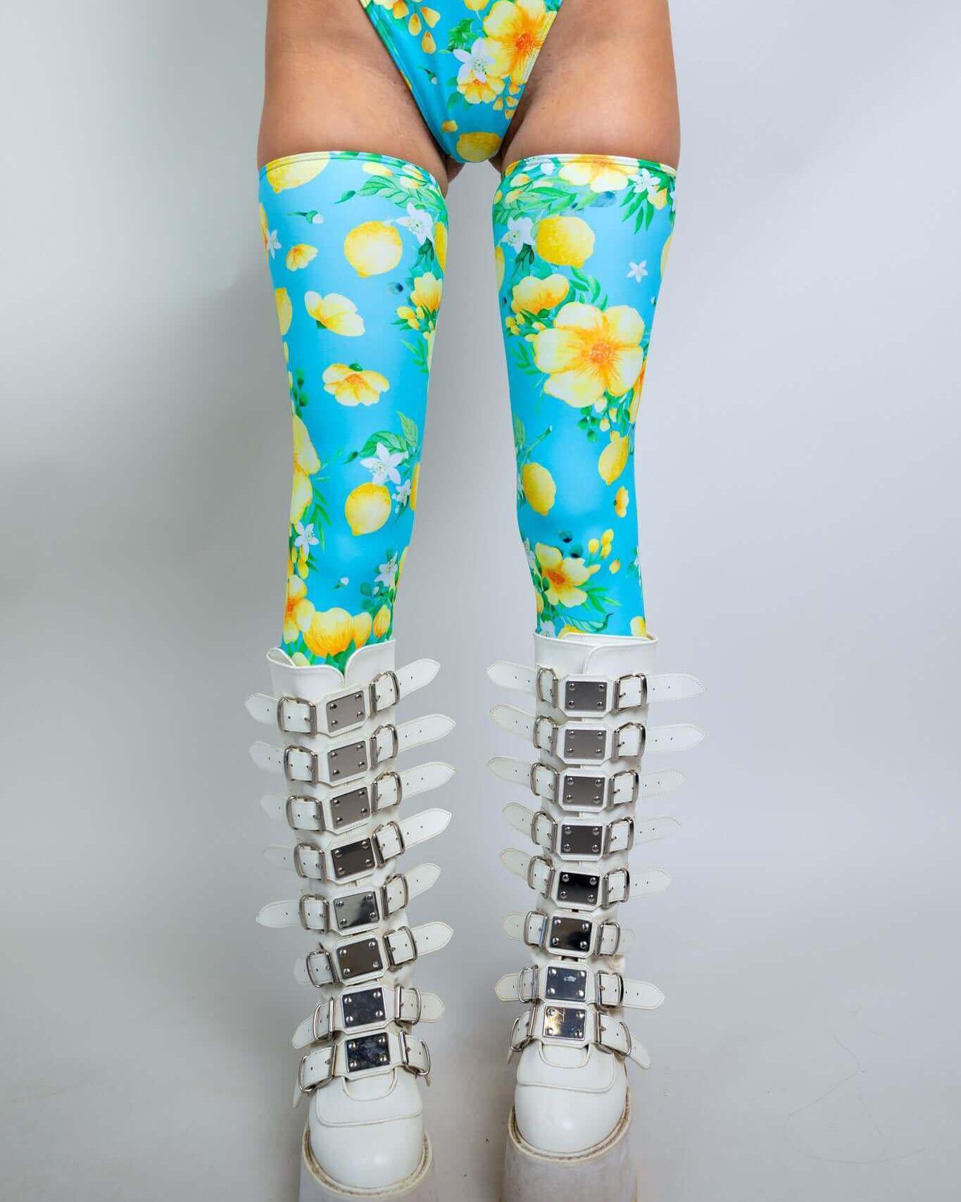 Lemon Drop Leg Sleeves in vibrant blue with lemon print, styled with chunky white platform boots for rave outfits.