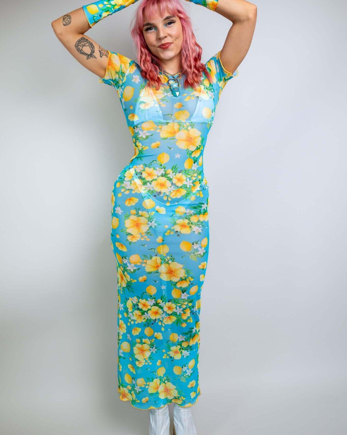 Model wearing a lemon drop mesh maxi dress with floral print, ideal for summer rave outfits and nightlife events.