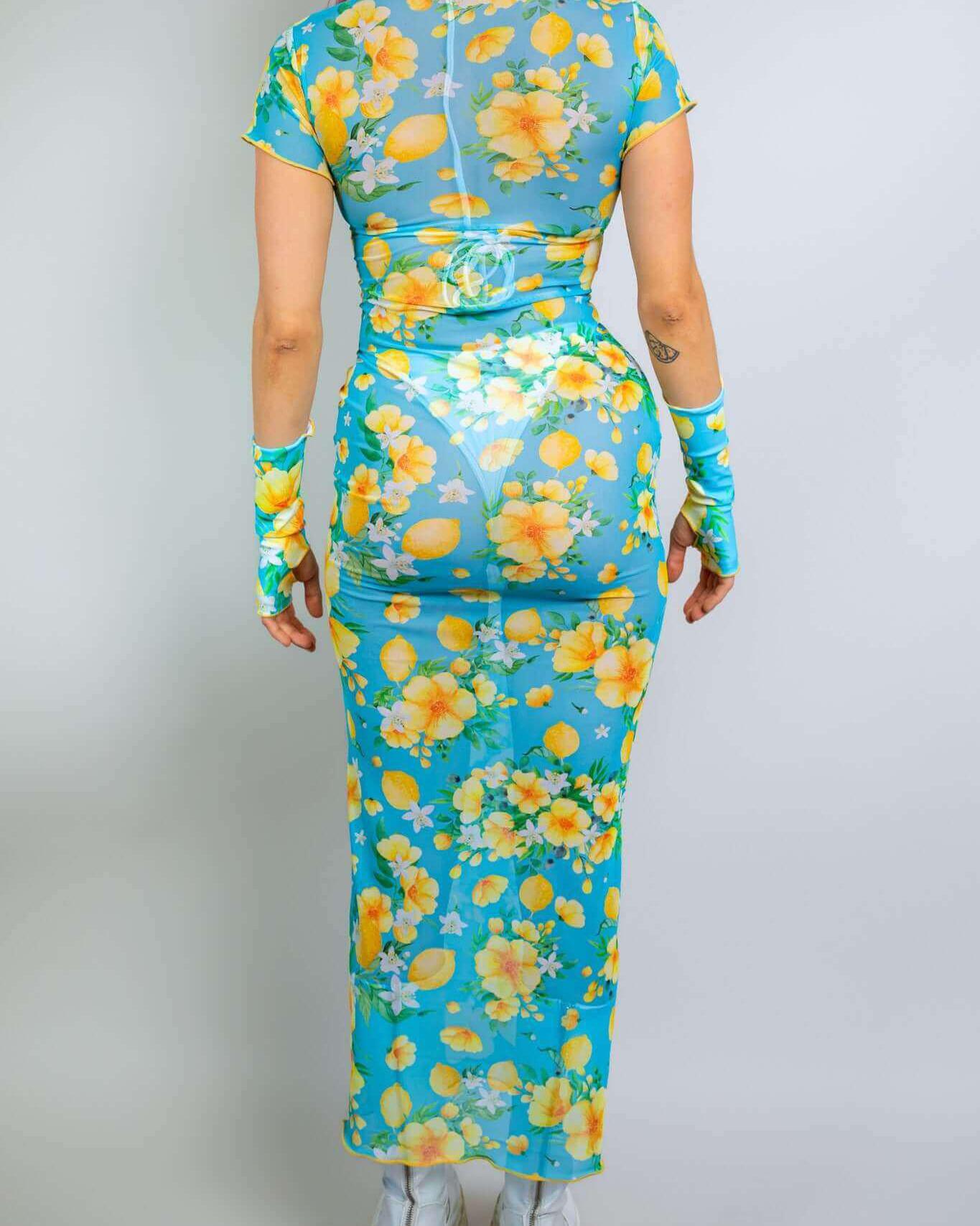 Model showcasing the Lemon Drop Mesh Baby Tee Maxi Dress with floral print, perfect for rave outfits and summer events.