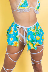 Woman modeling the Lemon Drop Swirl Skirt in vibrant blue with lemon design, perfect for rave outfits and summer looks.