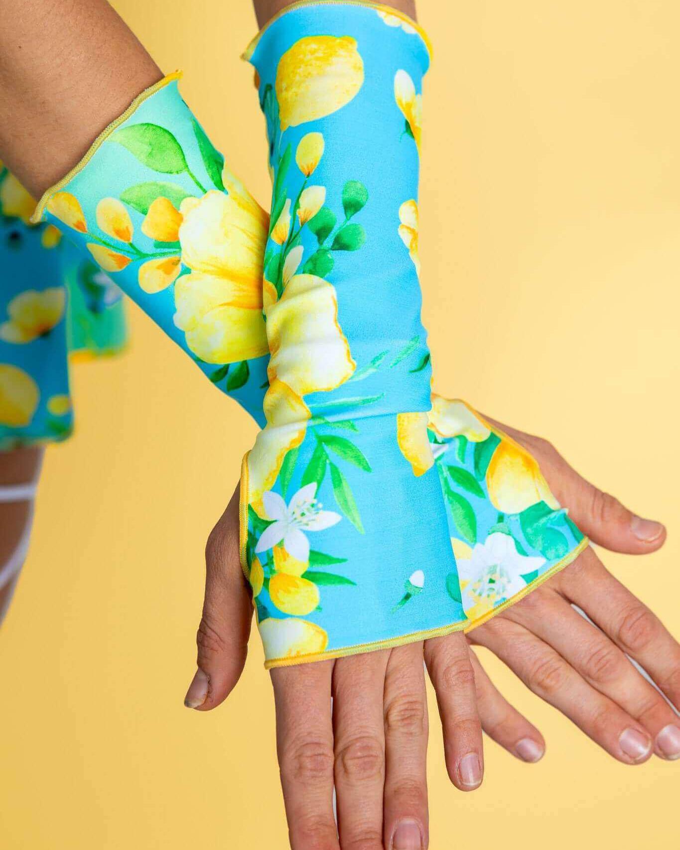 Lemon Drop Gloves in vibrant floral design, perfect for rave outfits, showcasing thumb holes and wrist-length coverage.