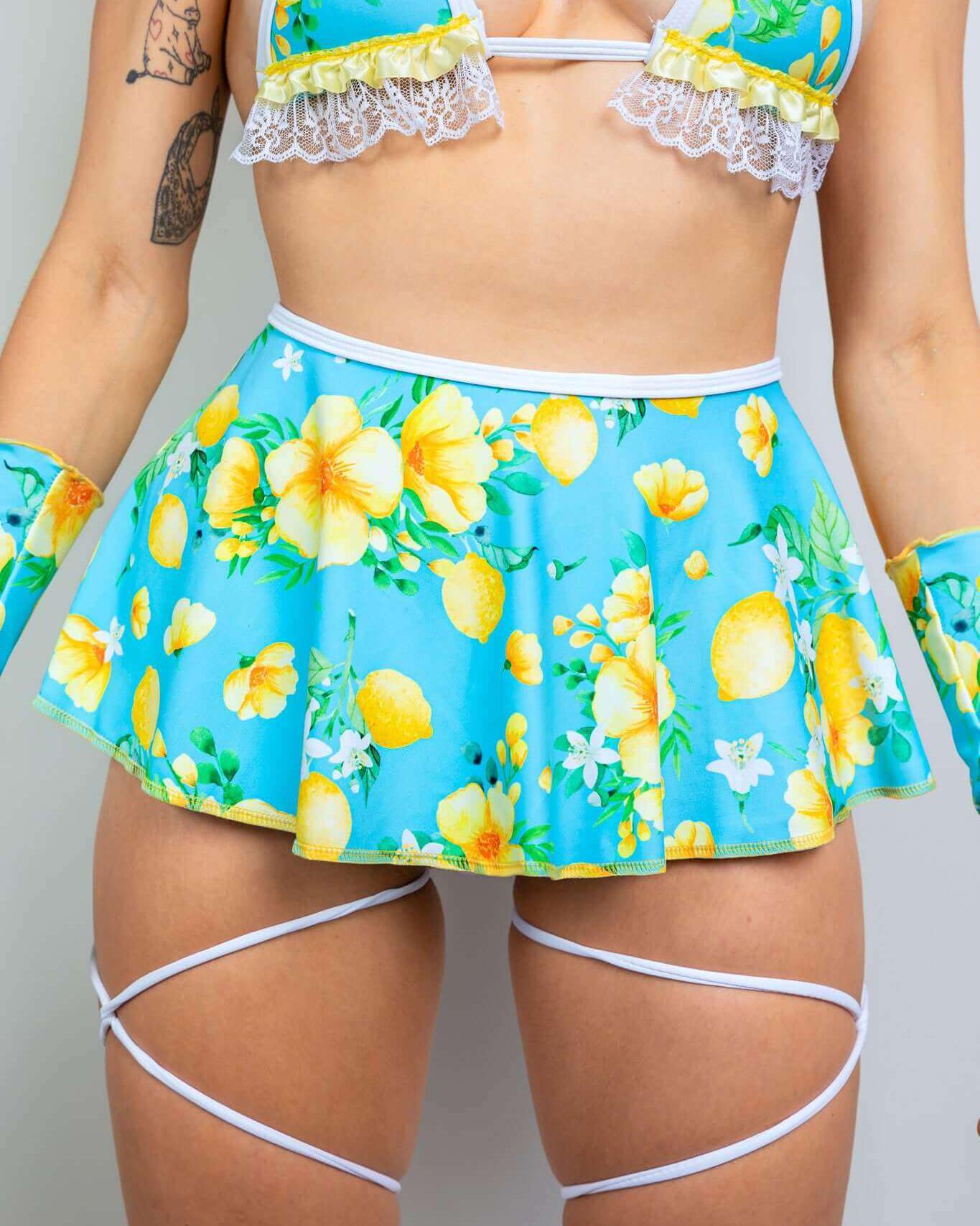 Model wearing Lemon Drop Swirl Skirt with floral print, paired with a matching bikini top and accessories for rave outfits.