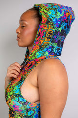 Close-up side profile of a model in a vibrant Freedom Rave Wear hood and bodysuit with intricate psychedelic patterns