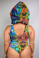 Rear view of a model  wearing a colorful Freedom Rave Wear hood with bodysuit with vibrant, psychedelic patterns