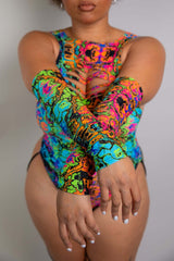 Detail view of a model in a colorful Freedom Rave Wear bodysuit, showcasing the psychedelic arm design and vibrant patterns.
