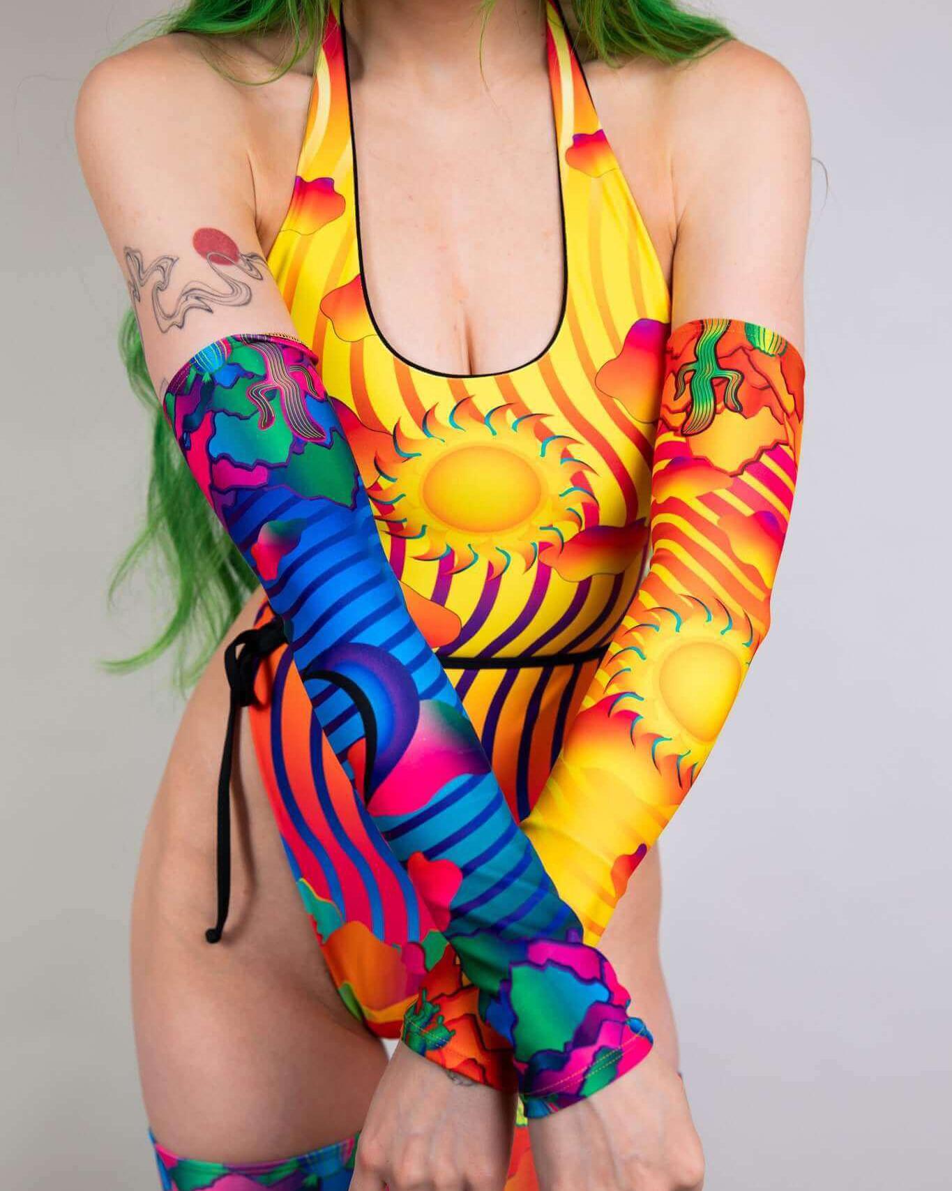 Colorful Mirage Arm Sleeves complementing a vibrant rave outfit, showcasing a unique design with sun patterns.