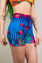 Freedom Rave Wear high-waisted rave shorts featuring vibrant blue, pink, and yellow psychedelic patterns and cloud motifs