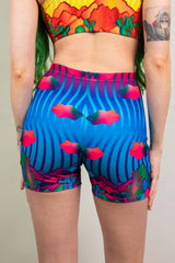 Eye-catching Freedom Rave Wear high-waisted shorts featuring a dynamic pattern with bold colors and psychedelic swirls, perfect for rave attire