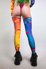 Freedom Rave Wear’s eye-catching leg sleeves in a kaleidoscope of vivid patterns, perfect for standout festival fashion.