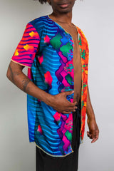 Man wearing a vibrant, partially opened tee from Freedom Rave Wear with colorful sun and cloud patterns, ideal for rave fashion