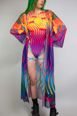 Colorful Freedom Rave Wear robe with vivid sun and wave patterns, modeled by a woman with green hair