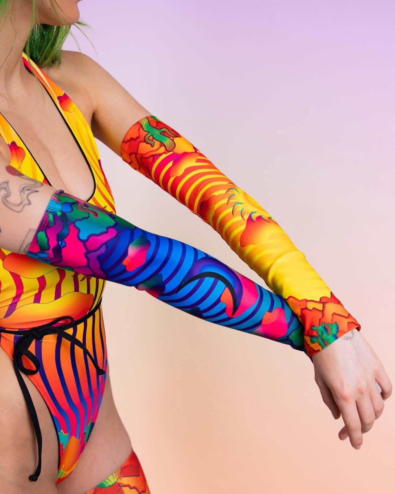 Vibrant Mirage arm sleeves in colorful patterns, perfect for rave outfits, enhancing any festival attire.