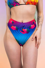 Vibrant high-waist thong from Freedom Rave Wear featuring a bold, colorful wave pattern, ideal for a standout rave outfit.