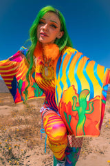 Woman with green hair in the desert setting wearing Freedom Rave Wear ensemble with a colorful scarf with a psychedelic pattern 