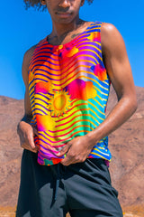 Man models a vibrant Freedom Rave Wear tank top with a bold sunset design, ideal for a striking rave outfit.