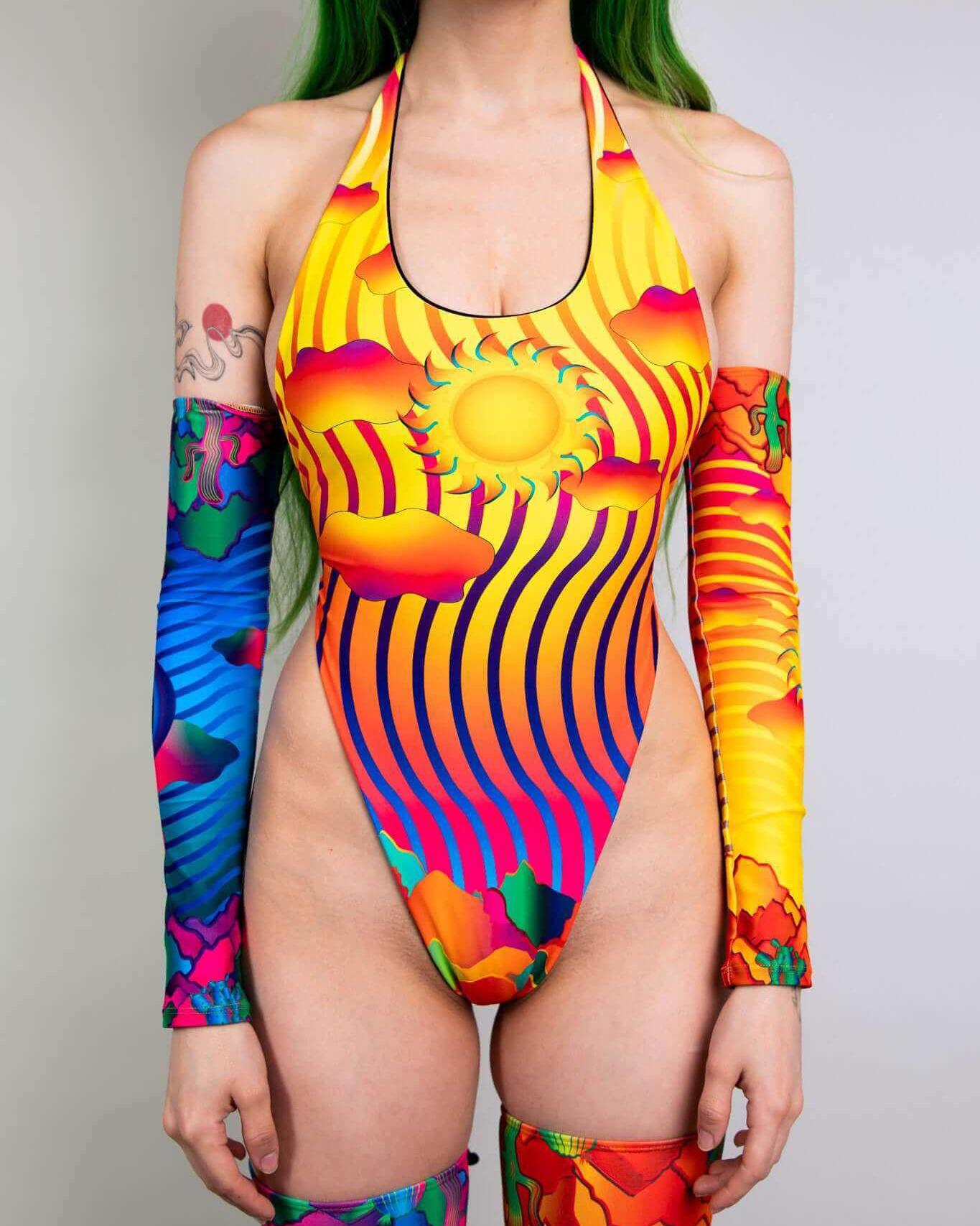 Colorful Mirage Temptation One Piece swimsuit featuring sun graphic and vibrant patterns, perfect for rave outfits.