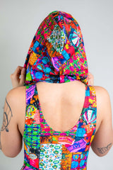 A girl facing away from the camera wearing a rainbow patchwork hood and matching bodysuit.