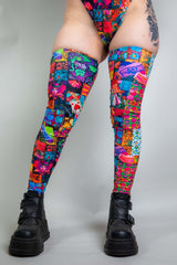 A photo of a woman's legs, wearing rainbow patchwork sleeves that go up to her mid thigh.
