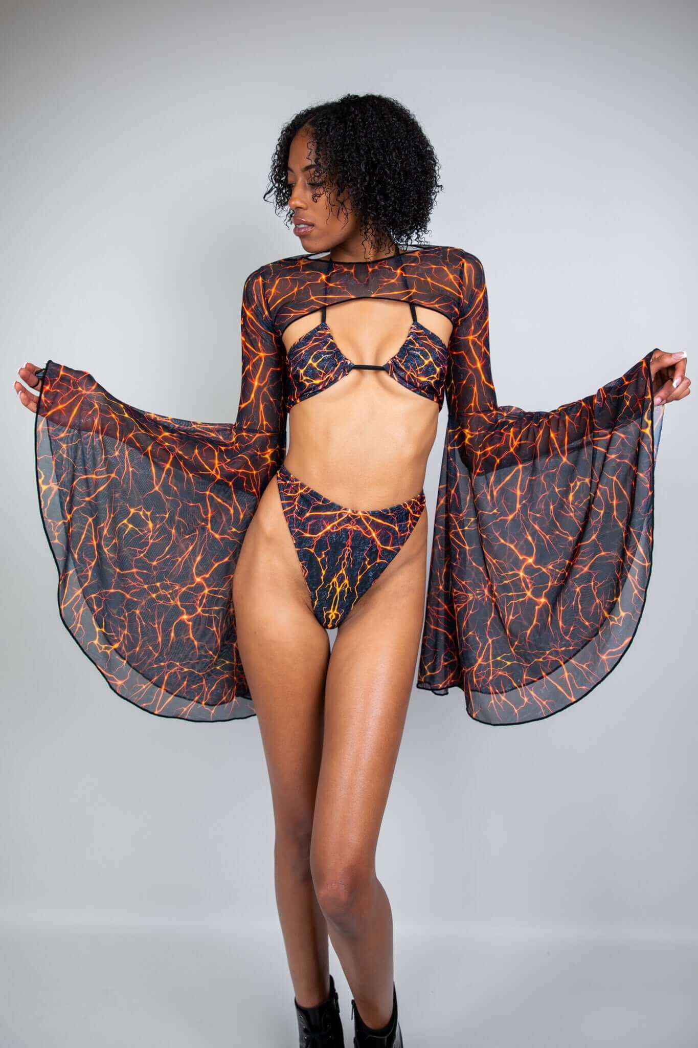 Freedom Rave Wear lava print rave bikini set with a sheer mesh bell-sleeve top. Perfect for making a bold, fiery statement at festivals and raves.